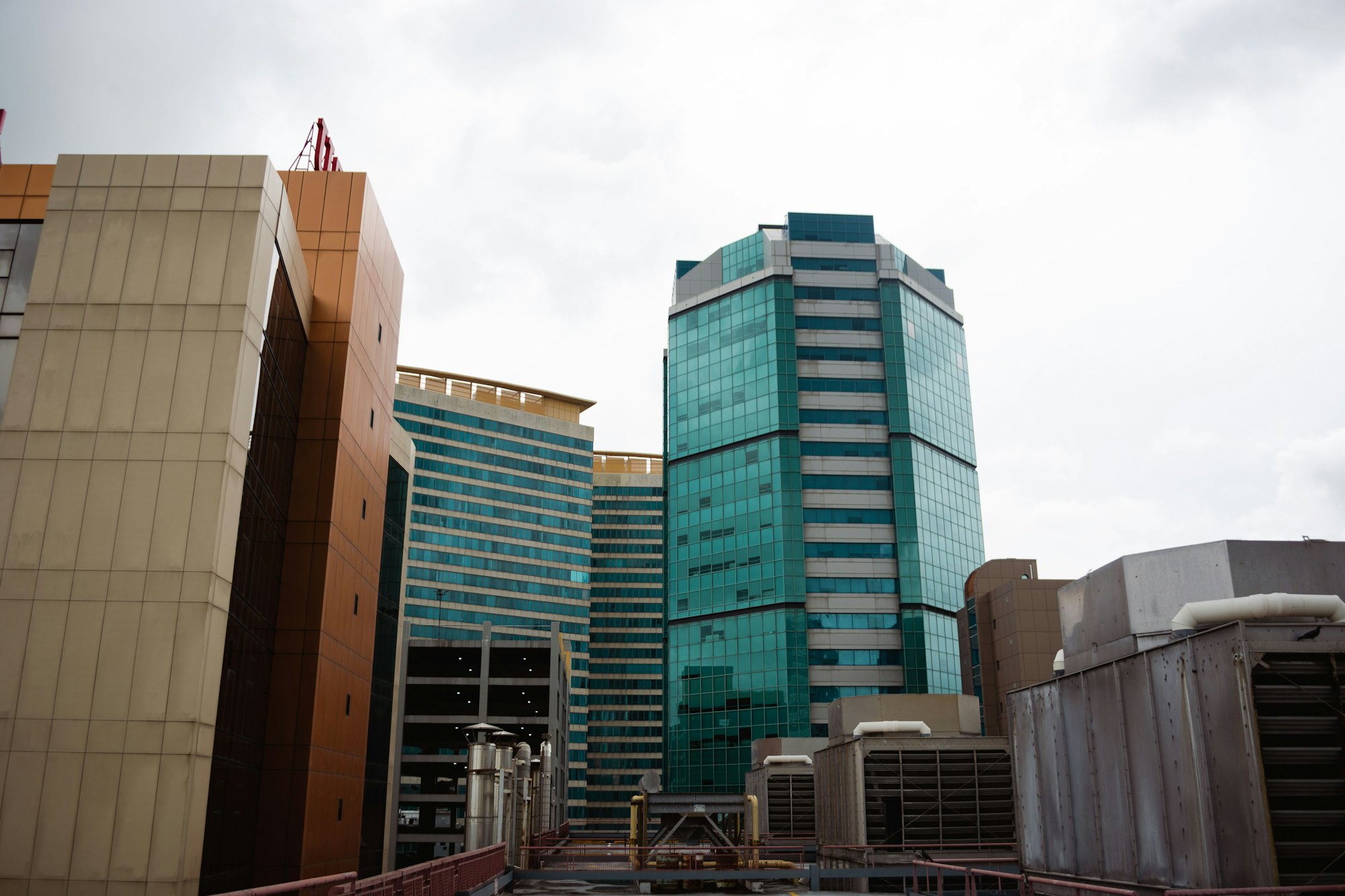 Glass and concrete office towers in Port of Spain, Trinidad and Tobago, under an overcast sky